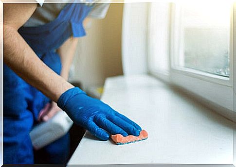 Man cleaning surface with disinfectant soap.