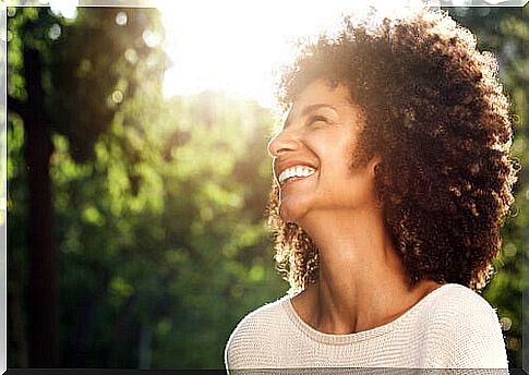 Woman smiling outdoors.