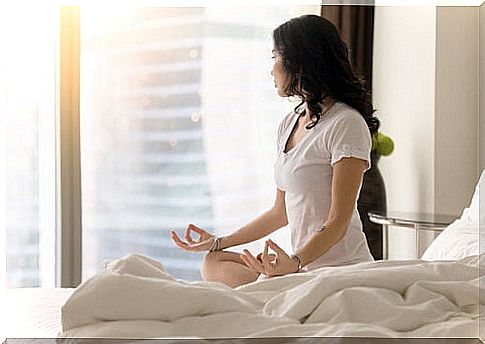 Woman meditating in her room 