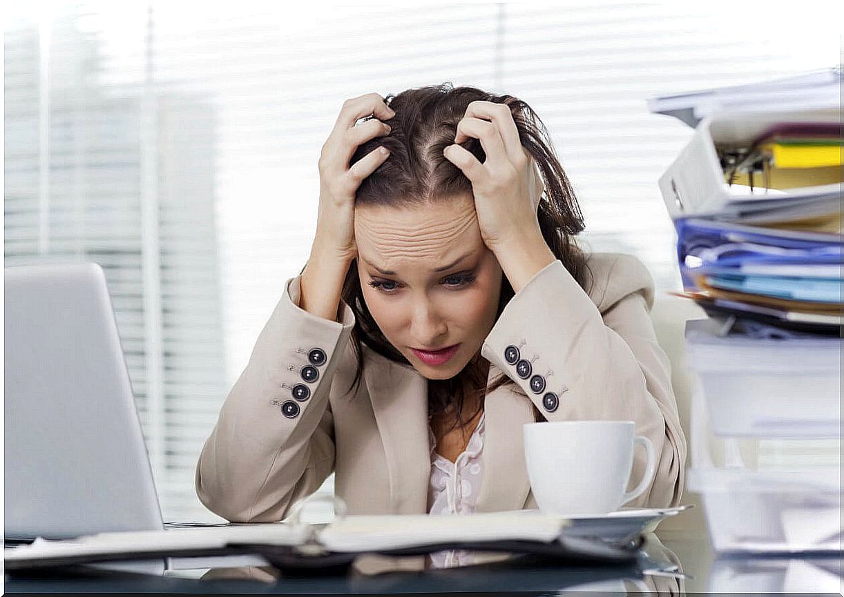 Woman with a lot of stress in the office.