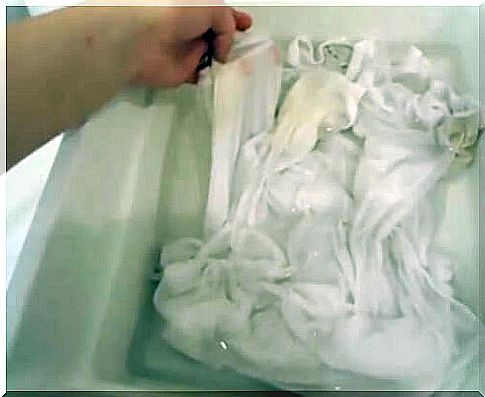 person washing white clothes